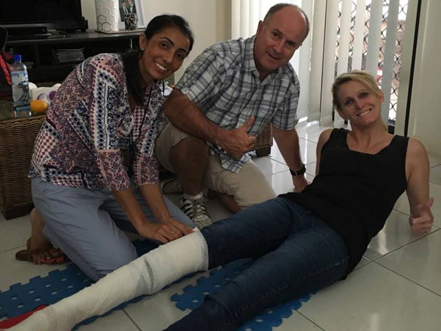 two students practice bandaging another students leg