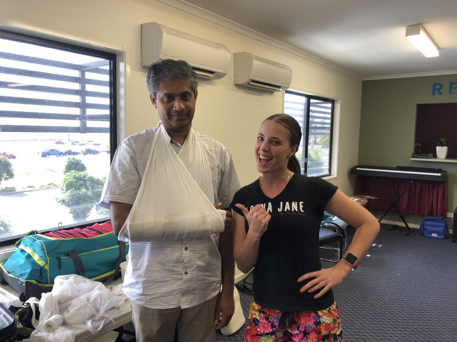 A student shows off a successful first aid sling technique