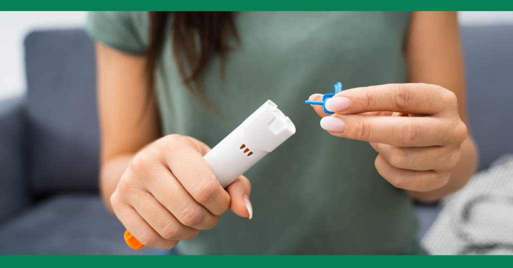 Close-up of a person removing the safety cap from an epinephrine auto-injector