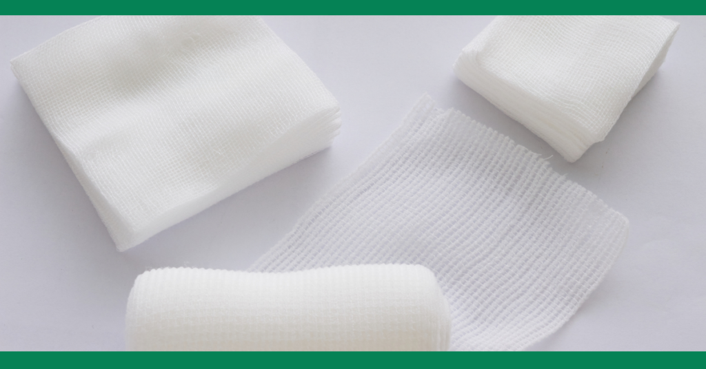  A selection of sterile gauze pads and bandages, arranged on a white background