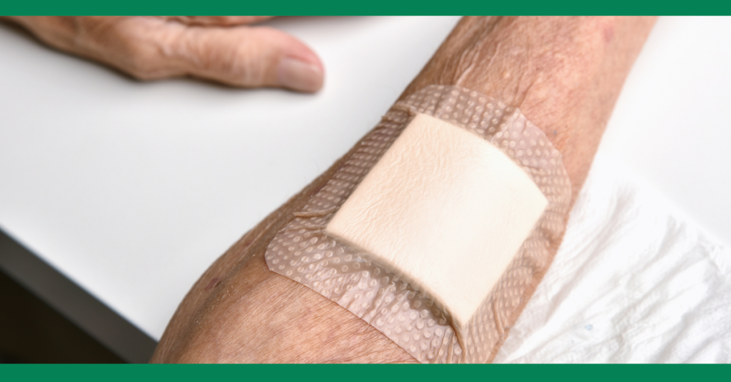  A close-up of a bandage applied to an elderly person's arm, emphasizing proper wound care.